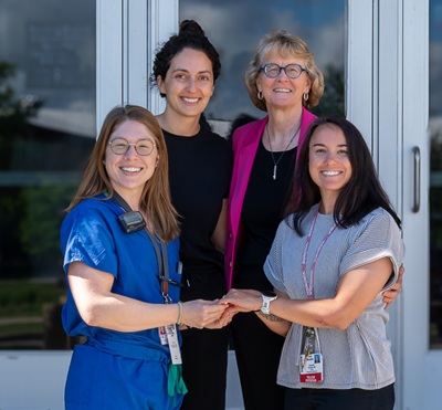 Three gynecologic oncology fellows and the UW Department of Ob-Gyn chair stand together, smiling.